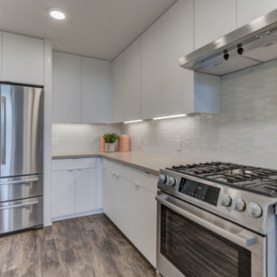 Open concept kitchen designs - L-shaped open concept kitchen photo in San Francisco with shaker cabinets, white cabinets, stainless steel appliances and an island