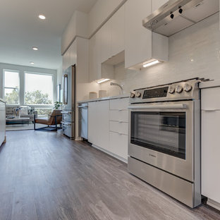 Open concept kitchen designs - Inspiration for a single-wall open concept kitchen remodel in San Francisco with an undermount sink, flat-panel cabinets, white cabinets, stainless steel appliances, an island and white countertops