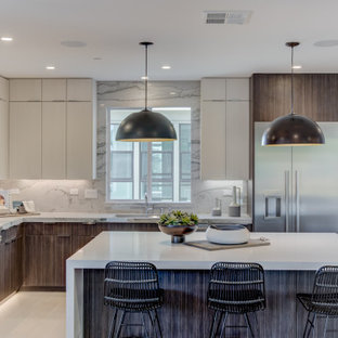 Contemporary kitchen photos - Example of a trendy l-shaped beige floor kitchen design in San Francisco with stainless steel appliances, an island, an undermount sink, flat-panel cabinets, gray cabinets, white backsplash, stone slab backsplash and white countertops