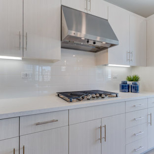 Open concept kitchen appliance - L-shaped open concept kitchen photo in San Francisco with an undermount sink, shaker cabinets, white cabinets, stainless steel appliances and an island