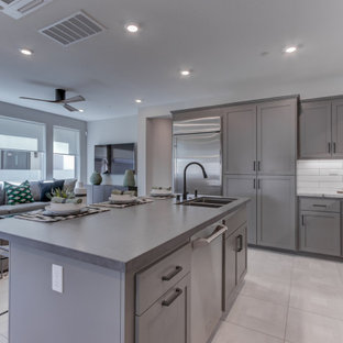 Open concept kitchen appliance - L-shaped open concept kitchen photo in San Francisco with an undermount sink, recessed-panel cabinets, gray cabinets, stainless steel appliances and an island