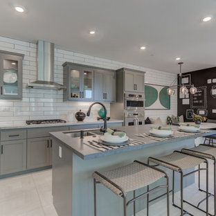 Open concept kitchen designs - L-shaped open concept kitchen photo in San Francisco with an undermount sink, recessed-panel cabinets, gray cabinets, stainless steel appliances and an island