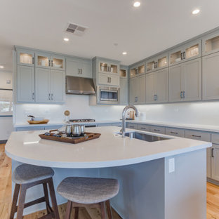 Open concept kitchen designs - Inspiration for a l-shaped open concept kitchen remodel in San Francisco with an undermount sink, recessed-panel cabinets, stainless steel appliances and an island
