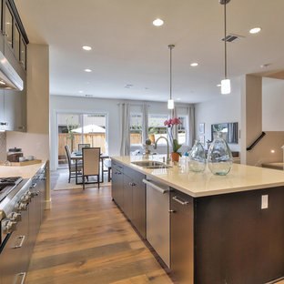Open concept kitchen ideas - Inspiration for a l-shaped medium tone wood floor open concept kitchen remodel in San Francisco with an undermount sink, flat-panel cabinets, dark wood cabinets, stainless steel appliances and an island