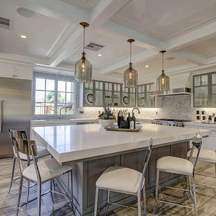 Large open concept kitchen remodeling - Open concept kitchen - large l-shaped light wood floor open concept kitchen idea in San Francisco with a drop-in sink, shaker cabinets, white cabinets, stainless steel appliances and an island