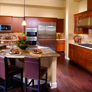 Large transitional eat-in kitchen designs - Inspiration for a large transitional l-shaped medium tone wood floor eat-in kitchen remodel in San Francisco with an undermount sink, shaker cabinets, medium tone wood cabinets, granite countertops, beige backsplash, stainless steel appliances and an island