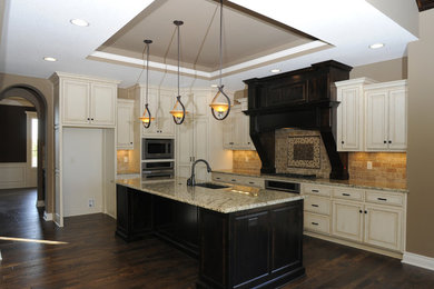 Mid-sized elegant u-shaped open concept kitchen photo in Kansas City with beige cabinets and an island