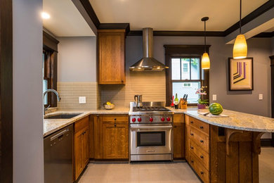 Mid-sized arts and crafts u-shaped porcelain tile eat-in kitchen photo in Minneapolis with a single-bowl sink, shaker cabinets, medium tone wood cabinets, granite countertops, gray backsplash, stainless steel appliances and subway tile backsplash