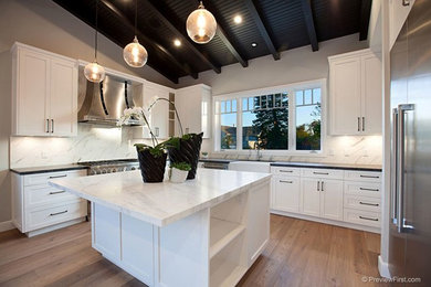 Mid-sized beach style light wood floor eat-in kitchen photo in San Diego with flat-panel cabinets and an island