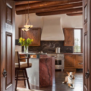 Inspiration for a mid-sized country kitchen in Orange County with raised-panel cabinets, dark wood cabinets, stainless steel appliances, with island and dark hardwood floors.
