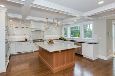 Example of a large transitional u-shaped dark wood floor and brown floor eat-in kitchen design in Boston with an undermount sink, beaded inset cabinets, white cabinets, quartzite countertops, white backsplash, mosaic tile backsplash, stainless steel appliances and an island