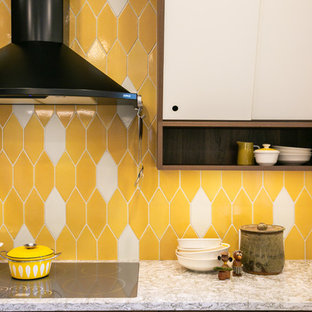 Design ideas for a large midcentury l-shaped eat-in kitchen in Denver with a drop-in sink, yellow splashback, ceramic splashback, light hardwood floors, with island, beige floor and beige benchtop.