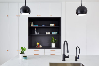 Inspiration for a modern galley eat-in kitchen remodel in Toronto with an undermount sink, flat-panel cabinets, white cabinets, ceramic backsplash, an island and white countertops