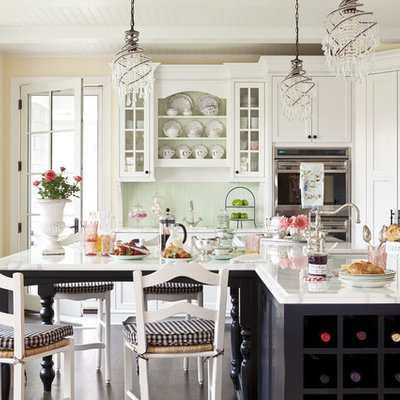 Open concept kitchen - mid-sized traditional l-shaped dark wood floor open concept kitchen idea in Minneapolis with recessed-panel cabinets, white cabinets, an undermount sink, marble countertops, green backsplash, stainless steel appliances and an island