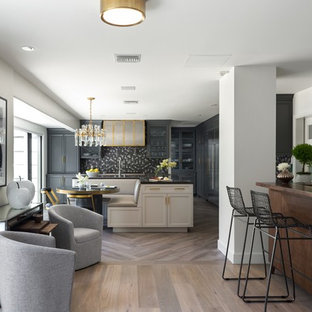 Design ideas for a large transitional single-wall eat-in kitchen in Los Angeles with recessed-panel cabinets, grey cabinets, with island, an undermount sink, multi-coloured splashback, porcelain splashback, panelled appliances, porcelain floors, brown floor and grey benchtop.