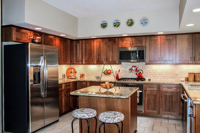 Mid-sized elegant u-shaped porcelain tile and beige floor eat-in kitchen photo in St Louis with a single-bowl sink, medium tone wood cabinets, granite countertops, white backsplash, ceramic backsplash, stainless steel appliances and an island