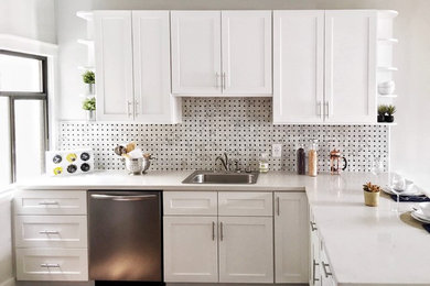 Inspiration for a small contemporary l-shaped kitchen/diner in San Francisco with a built-in sink, recessed-panel cabinets, white cabinets, tile countertops, white splashback, mosaic tiled splashback, stainless steel appliances, medium hardwood flooring and brown floors.