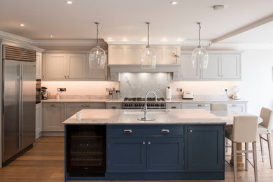 This is an example of a large modern single-wall kitchen/diner in Surrey with beaded cabinets, quartz worktops, grey splashback, stone slab splashback, an island and grey worktops.