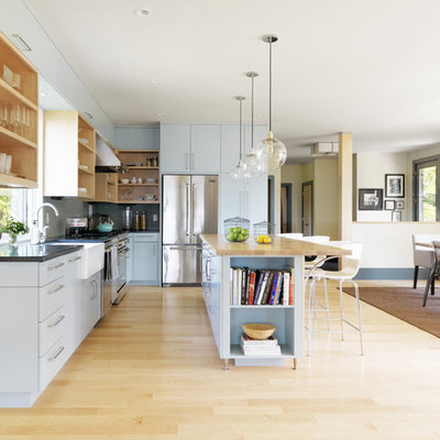 Trendy l-shaped eat-in kitchen photo in Burlington with a farmhouse sink, open cabinets, gray cabinets, blue backsplash and stainless steel appliances
