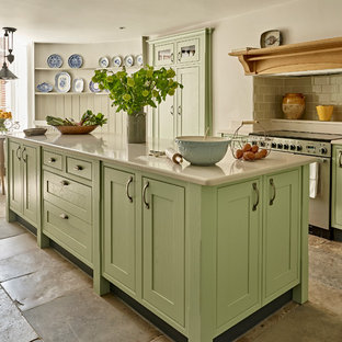 Medium sized rural single-wall kitchen/diner in London with green cabinets, quartz worktops, metro tiled splashback, stainless steel appliances, an island, shaker cabinets, beige splashback, beige floors and beige worktops.