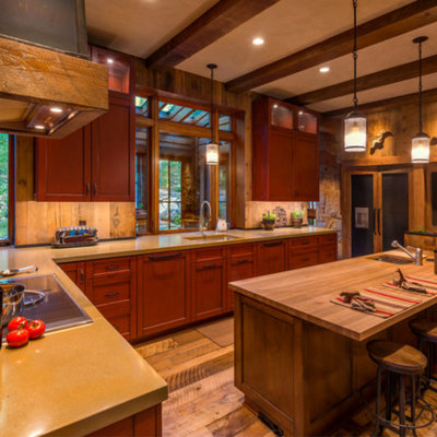 Large mountain style l-shaped eat-in kitchen photo in Other with an undermount sink, recessed-panel cabinets, red cabinets, wood backsplash, paneled appliances and an island