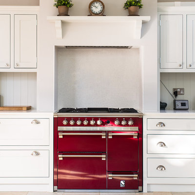 Example of a mid-sized classic single-wall ceramic tile enclosed kitchen design in Gloucestershire with shaker cabinets, quartzite countertops, white backsplash, colored appliances and white cabinets