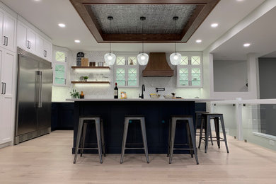 Inspiration for a large transitional light wood floor and coffered ceiling kitchen remodel in Other with an undermount sink, shaker cabinets, white cabinets, quartzite countertops, stainless steel appliances, an island and white countertops