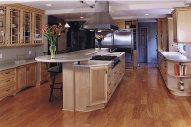 Example of a large transitional galley eat-in kitchen design in Sacramento with raised-panel cabinets, light wood cabinets, granite countertops, stainless steel appliances and an island