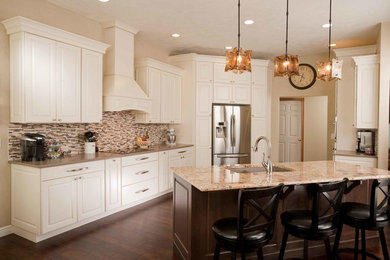 Inspiration for a mid-sized timeless l-shaped vinyl floor eat-in kitchen remodel in Wichita with a double-bowl sink, raised-panel cabinets, white cabinets, multicolored backsplash, matchstick tile backsplash, white appliances and an island