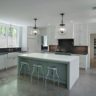 Transitional enclosed kitchen appliance - Transitional concrete floor and gray floor enclosed kitchen photo in Houston with a farmhouse sink, shaker cabinets, white cabinets, black backsplash, colored appliances, an island and soapstone countertops