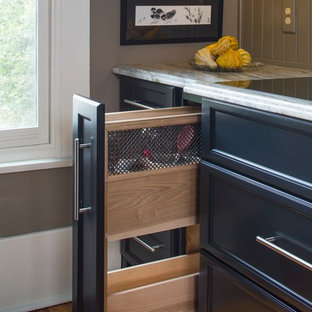 This is an example of a large country separate kitchen in Atlanta with a farmhouse sink, shaker cabinets, black cabinets, limestone benchtops, green splashback, stainless steel appliances, medium hardwood floors and with island.