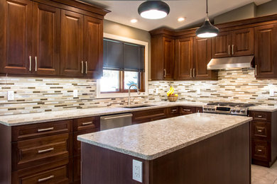 Inspiration for a mid-sized timeless u-shaped porcelain tile enclosed kitchen remodel in Orange County with an undermount sink, raised-panel cabinets, dark wood cabinets, granite countertops, multicolored backsplash, matchstick tile backsplash, stainless steel appliances and an island