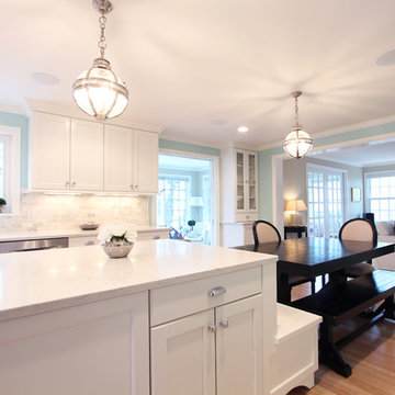 Table Seating Off Kitchen Island with White Cabinets