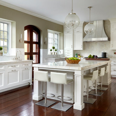 Example of a large transitional l-shaped dark wood floor and brown floor open concept kitchen design in New York with shaker cabinets, white cabinets, beige backsplash, an island, an undermount sink, marble countertops and stainless steel appliances