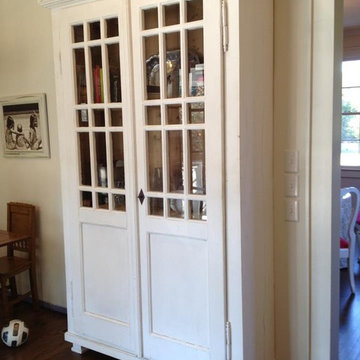 Tall white glass front cupboard is 8' tall.