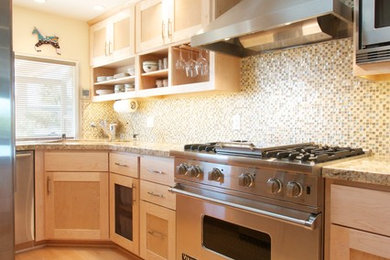 Example of a mid-sized trendy u-shaped light wood floor and beige floor eat-in kitchen design in San Diego with an undermount sink, shaker cabinets, light wood cabinets, granite countertops, multicolored backsplash, mosaic tile backsplash, stainless steel appliances and a peninsula