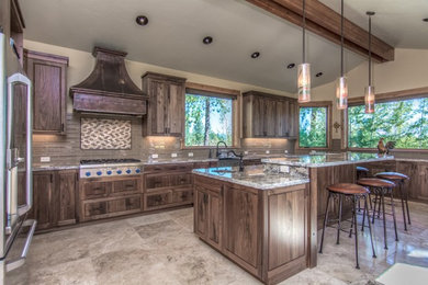 Mid-sized mountain style l-shaped eat-in kitchen photo in Other with dark wood cabinets, granite countertops, beige backsplash, stainless steel appliances and an island