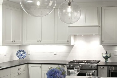 Example of a mid-sized trendy l-shaped kitchen design in Atlanta with shaker cabinets, quartz countertops and an island