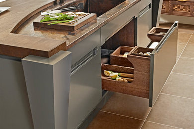 Example of a small asian u-shaped eat-in kitchen design in Other with recessed-panel cabinets, light wood cabinets, copper countertops, stone slab backsplash, an island and an integrated sink