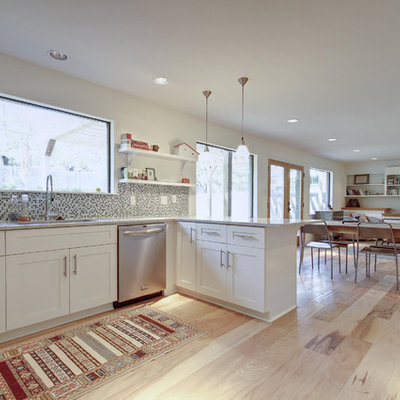 Open concept kitchen - eclectic open concept kitchen idea in Austin with mosaic tile backsplash, stainless steel appliances, white cabinets, shaker cabinets and multicolored backsplash