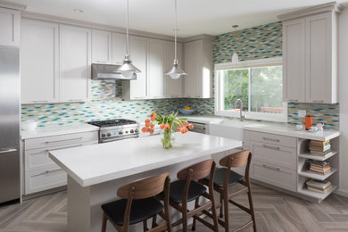 Inspiration for a mid-sized modern l-shaped open concept kitchen remodel in San Francisco with shaker cabinets, gray cabinets, quartz countertops, an island and white countertops