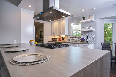 Example of a transitional kitchen design in Dallas with gray backsplash, an island and gray countertops