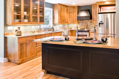 Inspiration for a mid-sized timeless u-shaped light wood floor and beige floor open concept kitchen remodel in Charleston with a double-bowl sink, shaker cabinets, medium tone wood cabinets, granite countertops, brown backsplash, stone slab backsplash, stainless steel appliances, an island and beige countertops