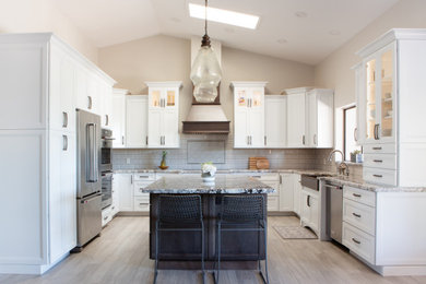 Mid-sized trendy u-shaped ceramic tile and gray floor eat-in kitchen photo in Phoenix with a farmhouse sink, white cabinets, granite countertops, gray backsplash, ceramic backsplash, stainless steel appliances, an island and multicolored countertops