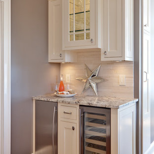 This is an example of a classic kitchen in Atlanta with shaker cabinets, white cabinets, granite worktops, beige splashback and stainless steel appliances.