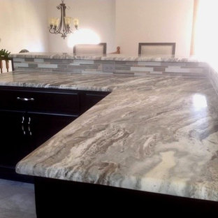 Inspiration for a mid-sized beach style l-shaped eat-in kitchen in New York with black cabinets, quartzite benchtops, multi-coloured splashback, subway tile splashback, ceramic floors and with island.
