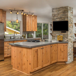 Mid-sized country galley open plan kitchen in Other with an undermount sink, shaker cabinets, light wood cabinets, concrete benchtops, grey splashback, glass tile splashback, stainless steel appliances, vinyl floors and with island.
