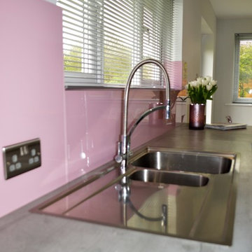 Textured concrete effect kitchen with baby pink accents