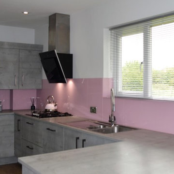 Textured concrete effect kitchen with baby pink accents