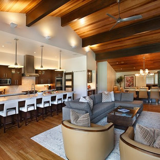 Large contemporary open concept kitchen ideas - Example of a large trendy galley light wood floor and brown floor open concept kitchen design in Salt Lake City with a farmhouse sink, flat-panel cabinets, dark wood cabinets, granite countertops, white backsplash, stone slab backsplash, stainless steel appliances and an island